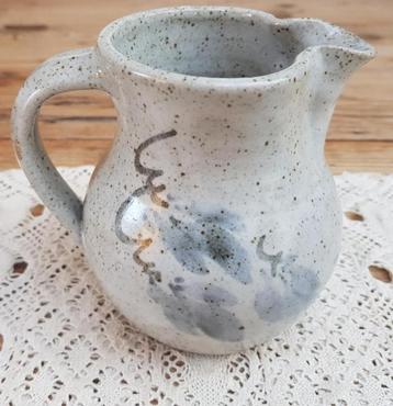 Gemeleerd landelijk gres kannetje met takken en bladeren beschikbaar voor biedingen