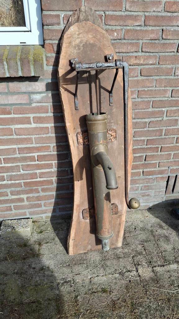Koperen waterpomp op hout voor de sier, Ophalen