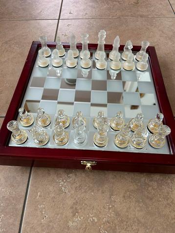 Twee schaakspellen houten kist en glazen stukken