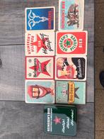 Heineken blikje met bierviltjes en porseleinen onderzetters., Verzamelen, Ophalen of Verzenden, Zo goed als nieuw, Viltje(s), Heineken