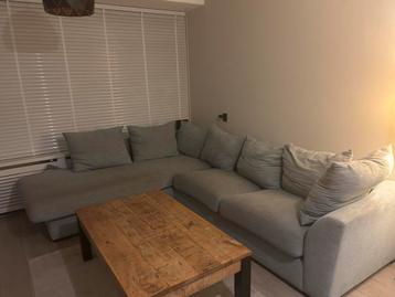 Blauw/grijze hoekbank te koop.