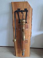 Koperen pomp op houten plank, Ophalen