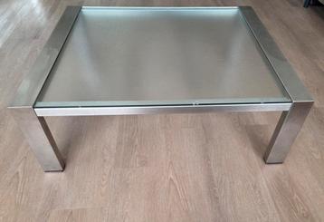 Salontafel met glazen blad en RVS poten. Merk Bony Design. beschikbaar voor biedingen