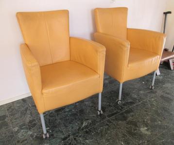 Twee stijlvolle gele leren designstoelen op wieltjes beschikbaar voor biedingen