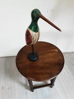 Houten vogel, Ophalen