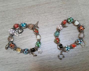 2 armbanden met bedels en glazen kralen beschikbaar voor biedingen