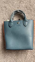 Licht blauwe tas met hengsel en dustbag, Sieraden, Tassen en Uiterlijk, Tassen | Damestassen, Ophalen of Verzenden, Zo goed als nieuw
