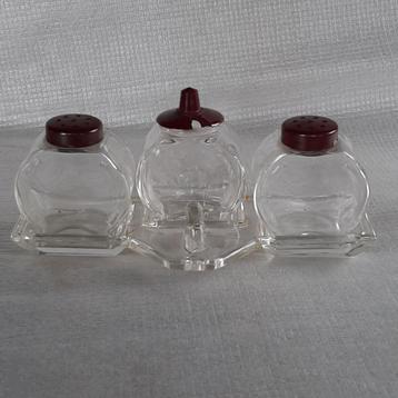 Oud peper, zout en mosterd stel van glas en bakeliet beschikbaar voor biedingen