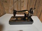 Antieke Singer handnaaimachine, Ophalen