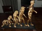 goudkleurig decoratief beeld dat de evolutie van de mens, Ophalen