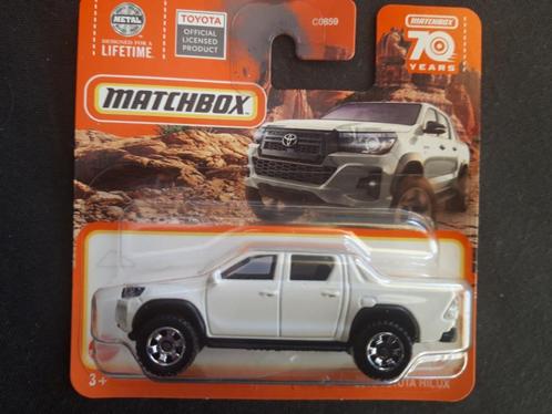 Matchbox Toyota Hilux doublecab wit, Hobby en Vrije tijd, Modelauto's | Overige schalen, Nieuw, Auto, Ophalen of Verzenden