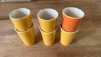 Hema melkbekers.  8 Gele en 1 oranje. Bieden per stuk., Ophalen of Verzenden, Overige stijlen, Kop(pen) en/of Schotel(s), Glas