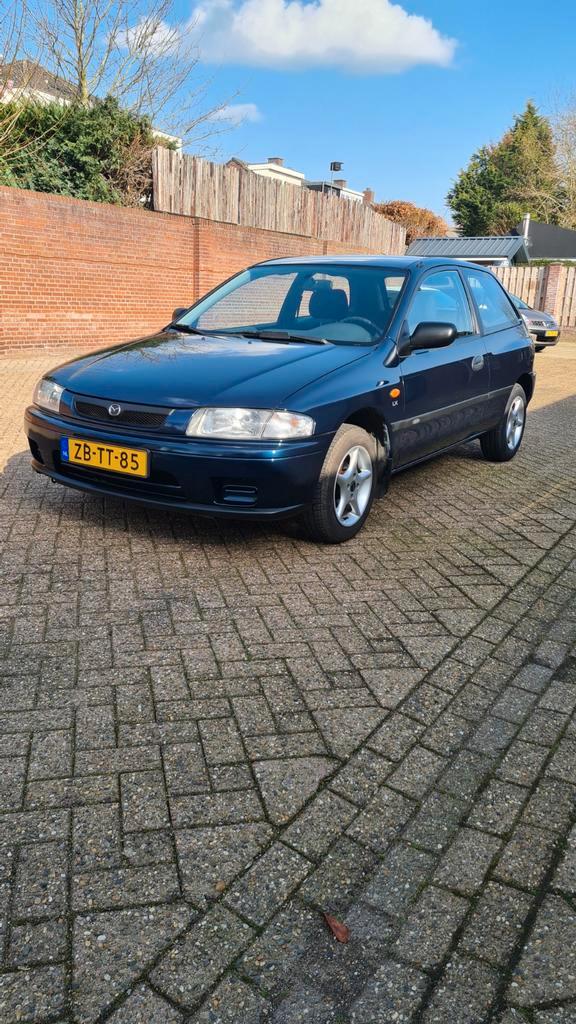 Mazda 323 1.3 P LX 1999 Blauw, weinig kilometers, Auto's, Mazda, Bedrijf, Airbags, Lichtmetalen velgen, Benzine, Hatchback, Handgeschakeld