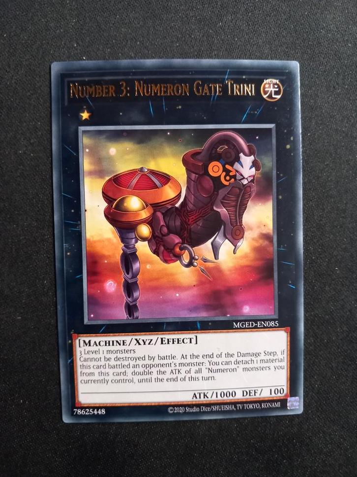 Maximum Gold: Number 3 Numeron Gate Trini 085 NM, Hobby en Vrije tijd, Verzamelkaartspellen | Yu-gi-Oh!, Zo goed als nieuw, Losse kaart