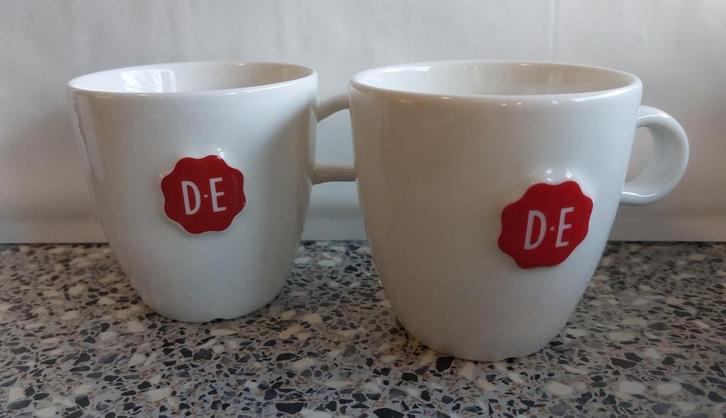 2 bekers mokken DE Wit Douwe Egberts met oor , Huis en Inrichting, Keuken | Servies, Zo goed als nieuw, Kop(pen) en/of Schotel(s)