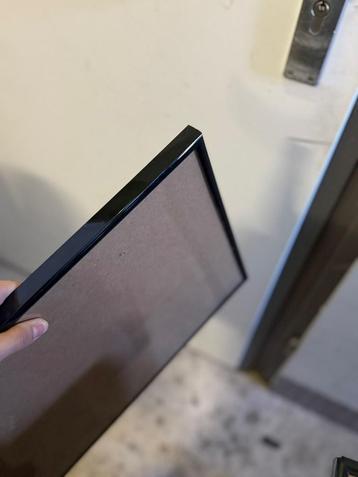 Zwarte metalen fotolijst beschikbaar voor biedingen