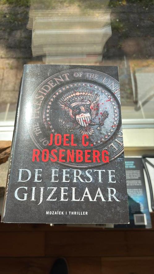 Joel C. Rosenberg - De eerste gijzelaar, Boeken, Thrillers, Zo goed als nieuw, Amerika, Ophalen of Verzenden