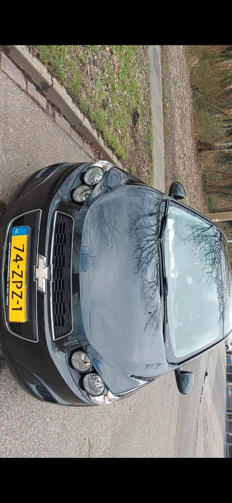 Chevrolet Aveo 2013, zwart, Auto's, Volvo, Particulier, Achteruitrijcamera, Alarm, Bluetooth, Elektrische ramen, Radio, USB, Benzine
