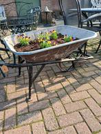 Ijzeren kruiwagen voor bloemen, Ophalen