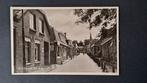Koudum Friesland Zicht op de Hoofdstraat met Winkel Reclame, Verzamelen, Ansichtkaarten | Nederland, Ophalen of Verzenden, Voor 1920