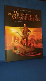 De Verborgen Geschiedenis, deel 1 + Genesis, hardcover. K1, Boeken, Stripboeken, Eén stripboek, Ophalen of Verzenden, Gelezen