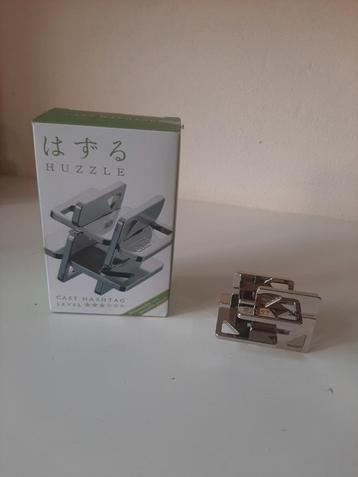 Huzzle Cast Hashtag Puzzel - Zo Goed Als Nieuw beschikbaar voor biedingen