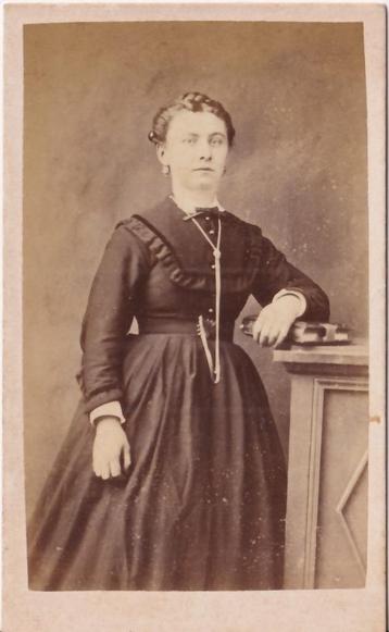 Carte de visite van een dame poserend met een fotoalbum (?) beschikbaar voor biedingen