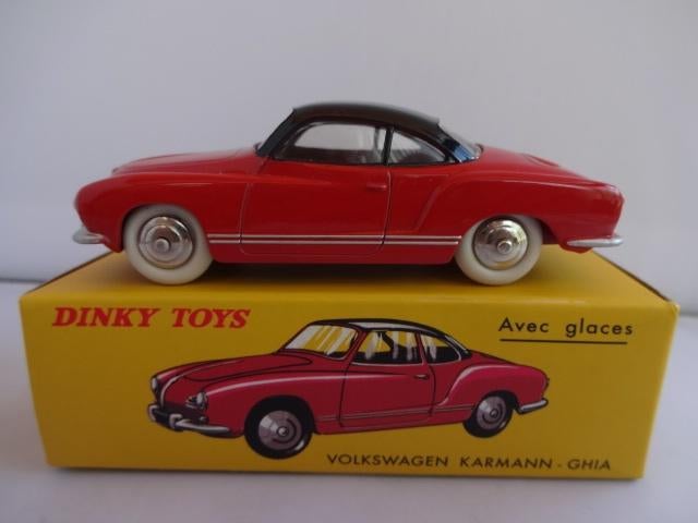 A Dinky 187 Volkswagen Karmann Ghia Coupe in red with black roof, spun hubs and white tyres in the c