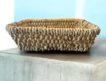 Een rechthoekige , geweven opbergmand. beschikbaar voor biedingen