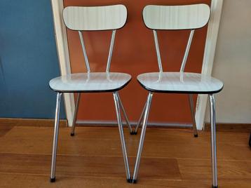 Twee witte (formica) stoelen beschikbaar voor biedingen
