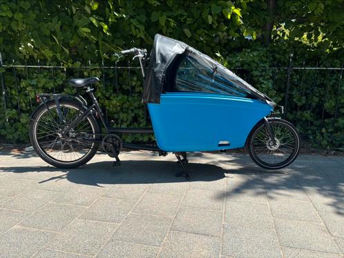 Dolly zwart met blauwe e-bakfiets met regentent, Fietsen en Brommers, Fietsen | Bakfietsen, Gebruikt, Overige merken, 2 kinderen