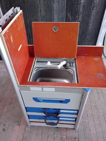 Kasje met losse koffers en wasbakje met stromend water pomp beschikbaar voor biedingen