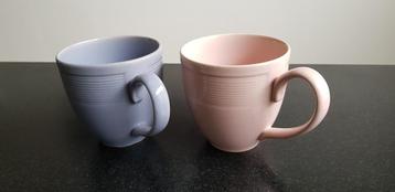 Twee bekers een roze en paarse voor thee of koffie 
