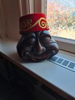 Leuk hoofd met mutsje. van steen, Ophalen