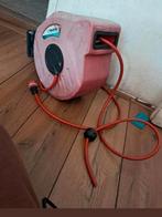 Te koop,Tuinslang met oprol hapsel.systeem15 meter lang., Tuin en Terras, Tuinslangen, Ophalen