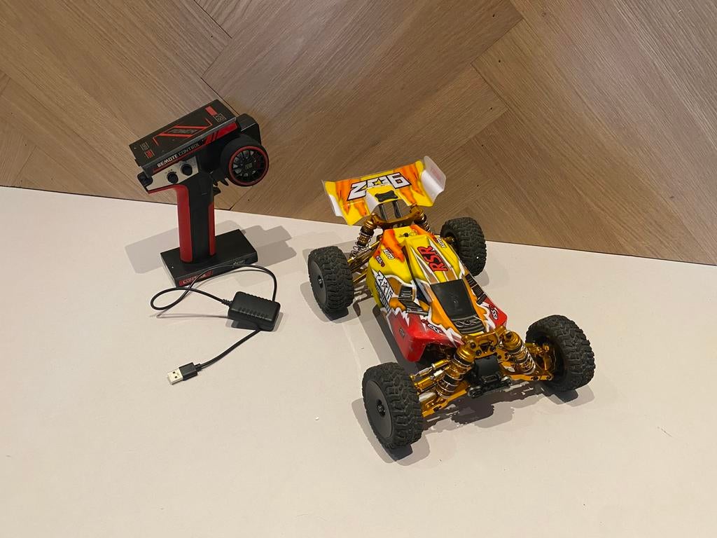 Bestuurbare auto RC WLtoys144010, Hobby en Vrije tijd, Modelbouw | Radiografisch | Auto's, Gebruikt, Auto offroad, Schaal 1:10