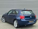 BMW 1-serie 116i Business+ navi xenon keyless, Gebruikt, Beige, 4 cilinders, Blauw