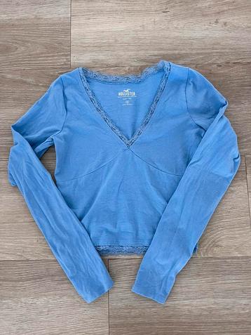 Hollister top maat S lange mouw blauw zgan 