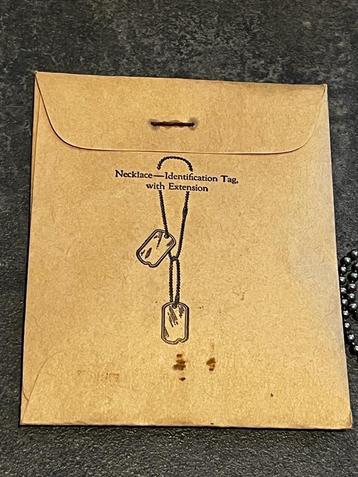 Amerikaanse dog tag ketting in zakje 1944, US beschikbaar voor biedingen