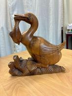 Oosters houten beeldje  aalscholver, Ophalen