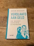 Gesigneerde Bram Bakker, Verslaafd aan geld., Boeken, Ophalen of Verzenden, Zo goed als nieuw