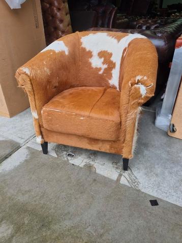 Fauteuil koeienhuid met schade voor weinig beschikbaar voor biedingen