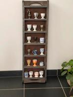 Oude bakstenenvorm met verzameling eierdopjes, Ophalen