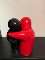 Omhelzende beelden zwart rood, Ophalen