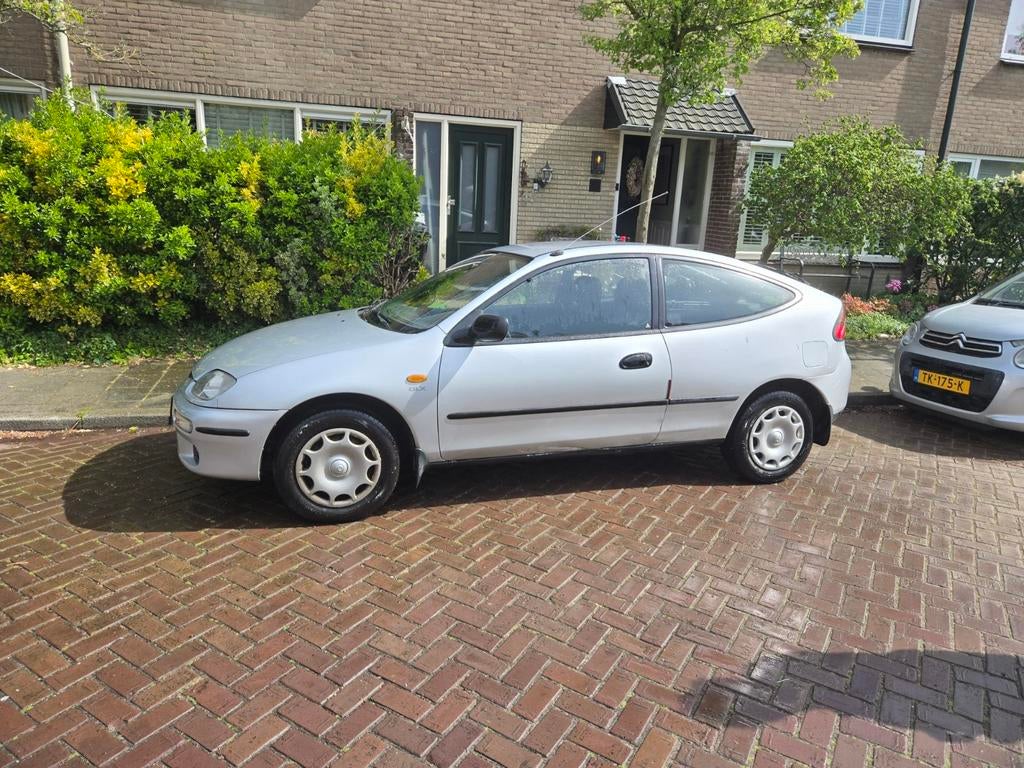 Mazda 323 1.8 I Coupe GLX AUT 1997 Grijs(automaat probleem), Auto's, Mazda, 4 cilinders, 49 €/maand, Origineel Nederlands, 1200 kg