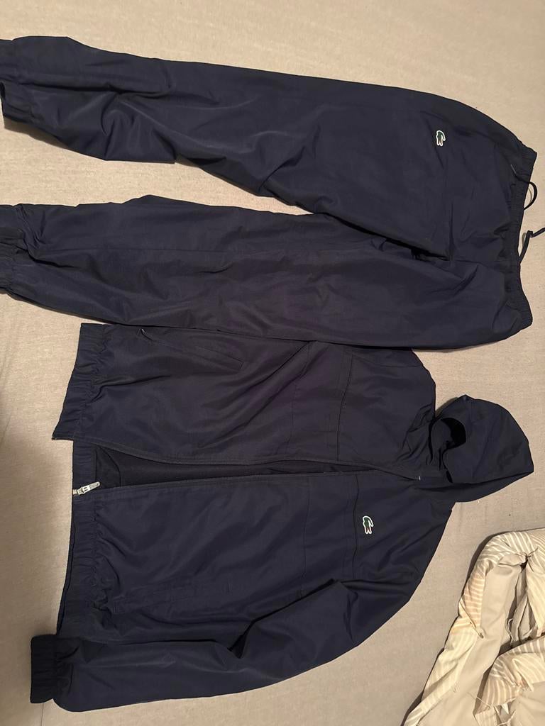 Lacoste trainingspak donkerblauw - Nieuw, Ophalen of Verzenden, Nieuw, Blauw