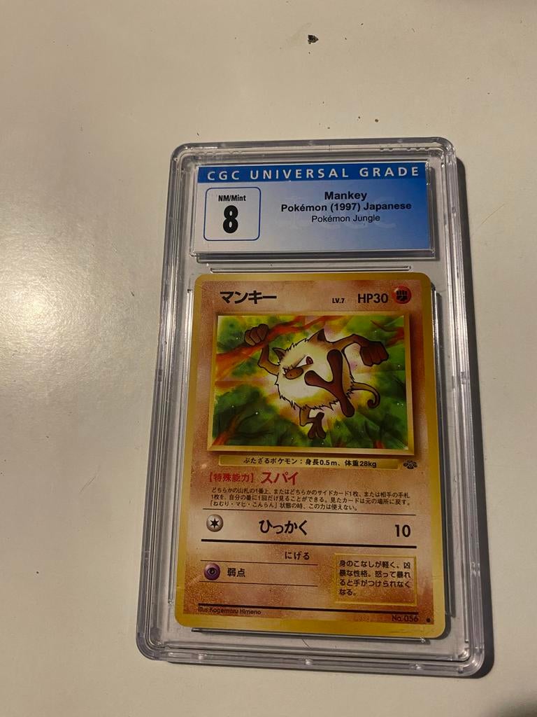 Mankey 1st Edition Pokémon Kaart (1997) Japans CGC 8, Ophalen of Verzenden, Zo goed als nieuw, Losse kaart