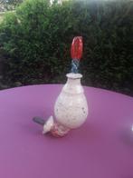 Raku pot met doppen, Ophalen