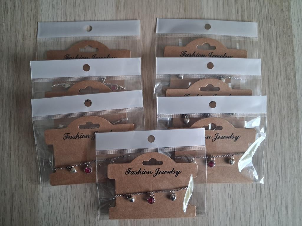 7x Kinderbedelarmbandjes - Zilverkleurig en Roze, Sieraden, Tassen en Uiterlijk, Kindersieraden, Ophalen of Verzenden, Nieuw, Roze