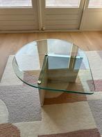 Glazen druppelvormige salontafel op travertin poot, Huis en Inrichting, Tafels | Salontafels, Ophalen, 50 tot 100 cm, 50 tot 100 cm